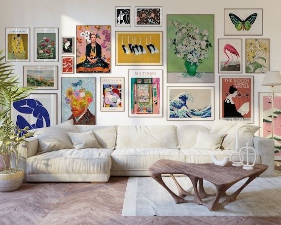 Stue med hvid sofa og farverig billedvæg i mange kunststile